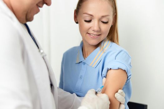 the doctor makes an injection into the hand of a hospital health patient. High quality photo