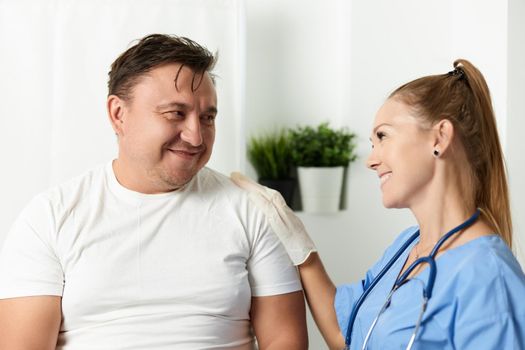 cheerful woman doctor next to patient health care hospital. High quality photo