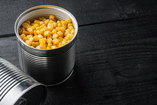 Sweet corn grains, on black wooden table background with copy space for text