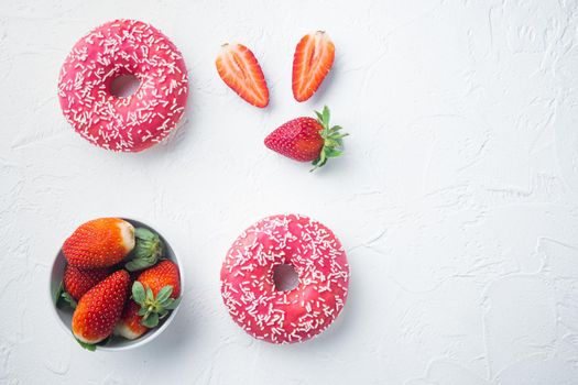 Pink donut with crumble, on white background, top view flat lay with copy space for text