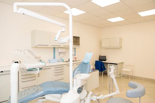 Interior of the dental office with a chair and tools for dental treatment.
