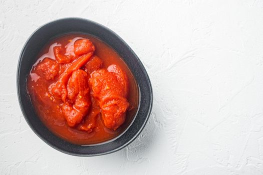 Whole canned tomatoe, on white background, top view flat lay with copy space for text