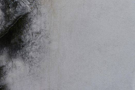 The texture of a gray concrete wall with scratches and stains on the surface.Texture or background