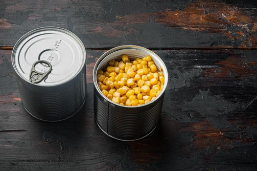 Lot of pieces of canned yellow corn, on old dark wooden table background