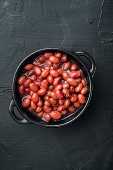 Red beans canned food, on black background, top view flat lay
