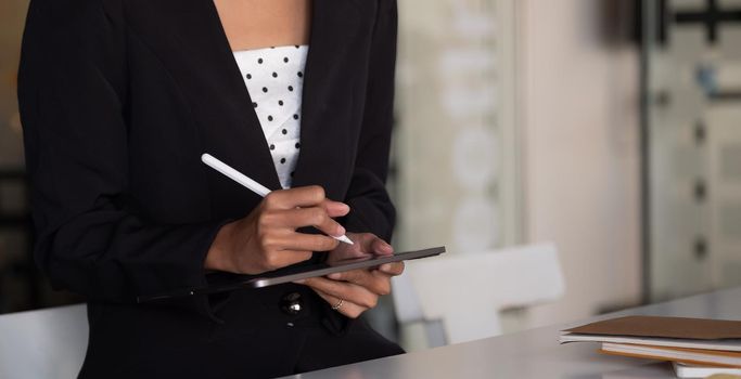 Businesswoman working on smart tablet for note data