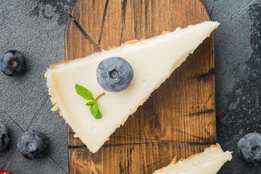 Classic New York Cheesecake, sliced, on gray background, top view flat lay