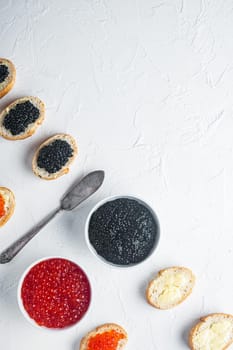 Sandwiches with red and black caviar baguette, on white background, top view flat lay with copy space for text