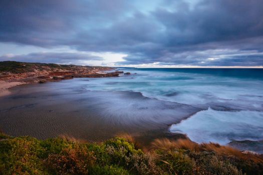 The idyllic Pearses Beach and headland around Pirates Bay Cove on a hot summer's evening near Blairgowrie, Victoria, Australia