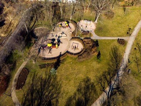 Aerial drone look to playground in  green park with long paths