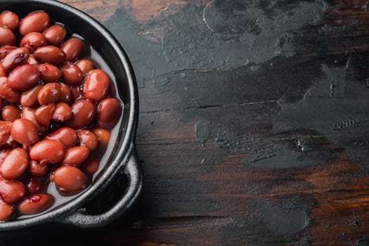 Japanese canned food ingredient, sweet red beans, on old dark wooden table background with copy space for text