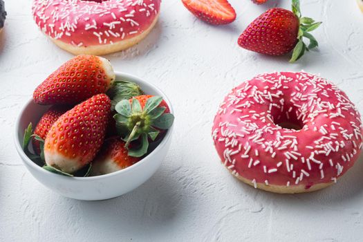 Pink strawberry flavor donuts, on white background