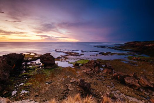 The idyllic Pearses Beach and headland around Pirates Bay Cove on a hot summer's evening near Blairgowrie, Victoria, Australia