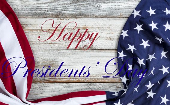 Happy Presidents Day text message with draped US flag on bottom of white rustic wood
