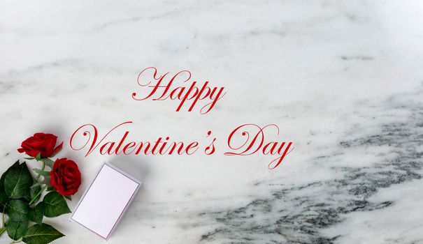 Happy Valentines Day with lovely red rose flowers and gift box on natural marble stone background with holiday text message