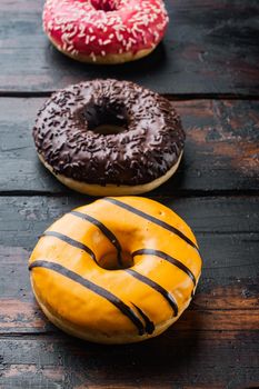 Donuts fresh set, on old dark wooden table background