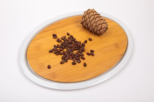 The fruit of Siberian cones - pine nuts on a kitchen cutting board, is a delicious, nutritious and healthy product.