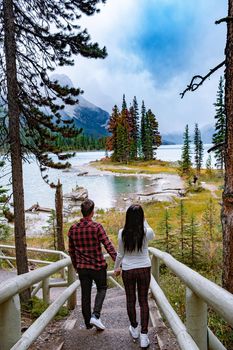 Spirit Island in Maligne Lake, Jasper National Park, Alberta, Canada. The Canadian Rockies, couple visit Spirit Island at Maligne lake