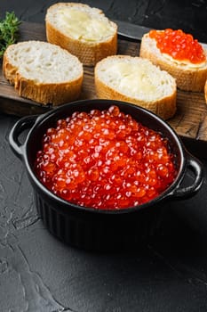 Canape with Red Salmon Caviar, for New Year, on black background