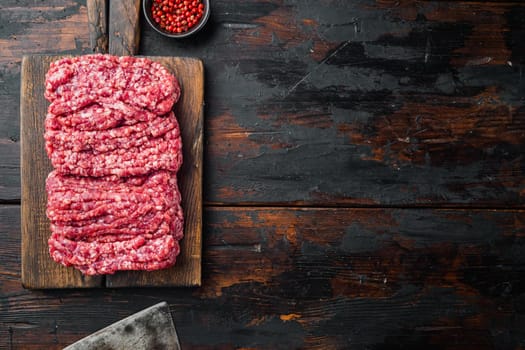 Minced marble beef meat, on old dark wooden table background, top view flat lay with copy space for text