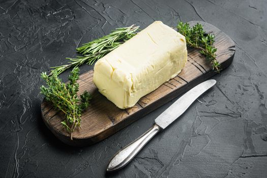 A piece of fresh butter, on black background