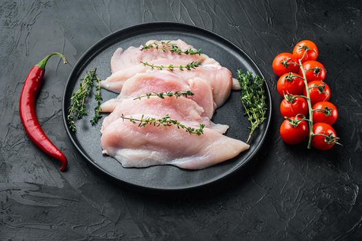 Raw chicken cutlet breast fillet, on black background