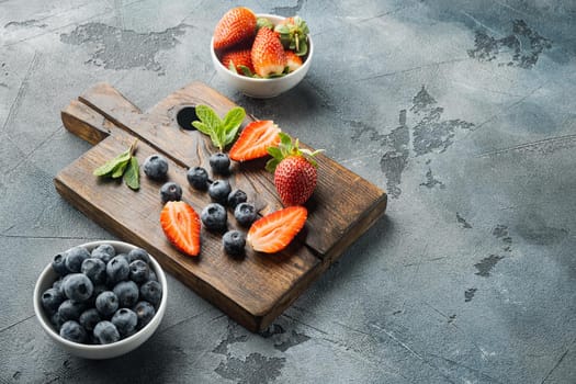 Ripe Strawberries and Blueberrie, on gray background with copy space for text