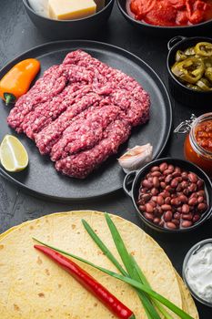Ingredients for mexican quesadilla with salsa sauce, on black background