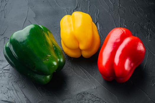 Colorful green , red and yellow pepper, on black background