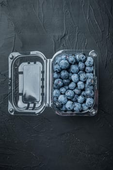 Quarts of blueberrie, on black background, top view flat lay