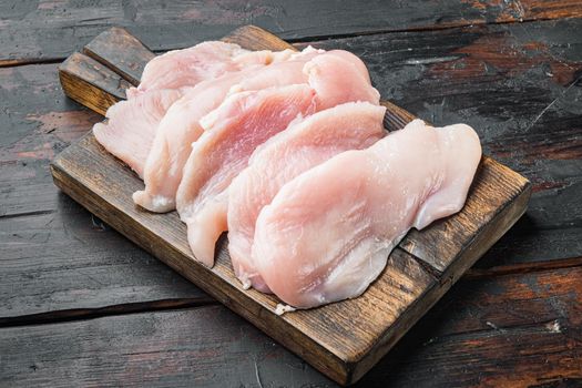 Raw chicken cutlet breast fillet, on old dark wooden table background