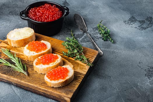 Bruschette with butter red caviar, on gray background with copy space for text