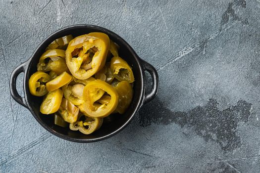 Jalapeno pickled and sliced, on gray background, top view flat lay with copy space for text