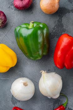 Green bell pepper and onions, on gray background
