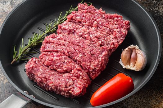 Fresh minced meat, ground beef, on old dark rustic background