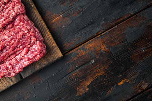 Mince. Ground meat with ingredients for cooking, on old dark wooden table background, top view flat lay with copy space for text