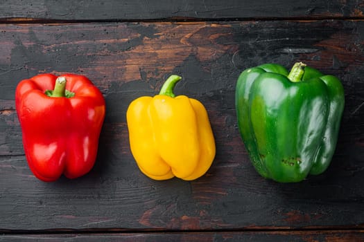 Sweet bell pepper, on old dark wooden table background, top view flat lay
