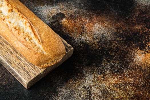 Baguette bread, on old dark rustic background with copy space for text