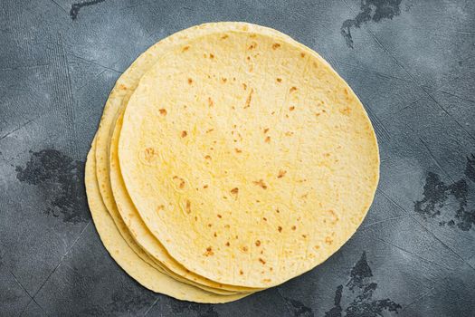 Fresh yellow corn tortilla, on gray background, top view flat lay with copy space for text