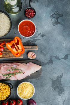 Mexican food ingredients Chicken Enchilada, Rice Casserole, on gray background, top view flat lay with copy space for text