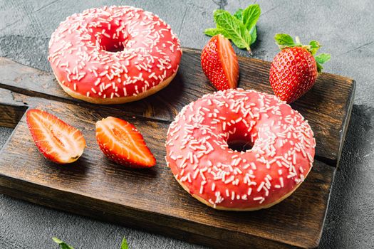 Pink donut with crumble, on gray background