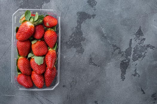 Fresh, red strawberry, on gray background, top view flat lay with copy space for text