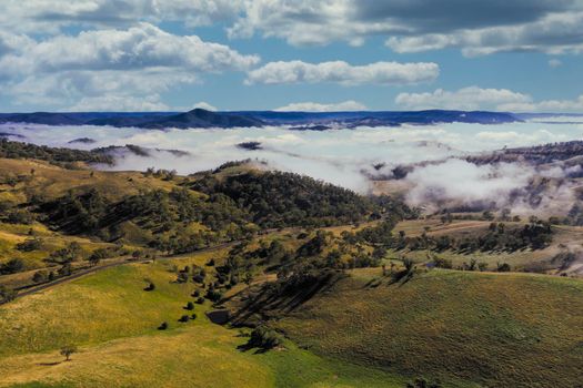 Aerial view of low-level clouds in a large green valley in the Central Tablelands in regional New South Wales Australia