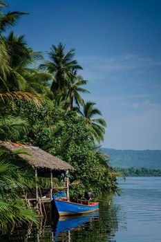 traditional boat and jungle hut on the tatai river in the cardamom mountains of cambodia