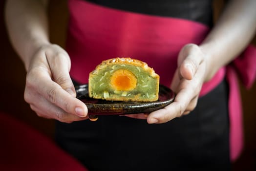 waitress serving traditional chinese gourmet mooncakes festive sweet food closeup