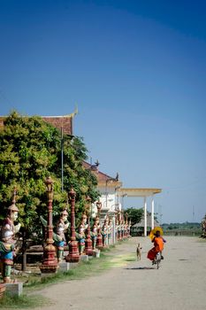 buddhist monk street scene walking outside Wat Svay Andet Pagoda UNESCO site in Kandal Province Cambodia