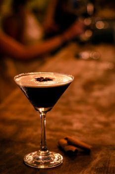 espresso martini cocktail drink in cozy dark bar interior at night