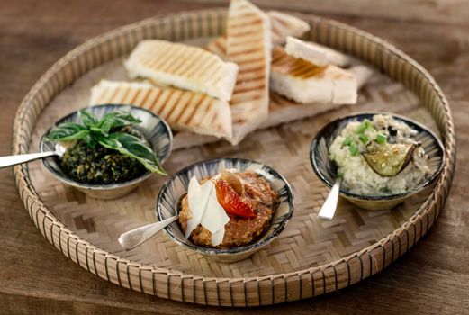 vegetarian turkish mezze snack tapas platter on rustic wood restaurant table