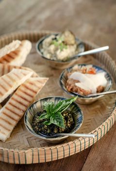 vegetarian turkish mezze snack tapas platter on rustic wood restaurant table