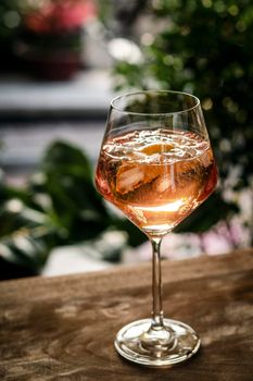traditional french 'Piscine' rose wine spritzer with orange cocktail drink on table outside
